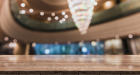 Empty wooden table top with lights bokeh on blur luxury restaurant background