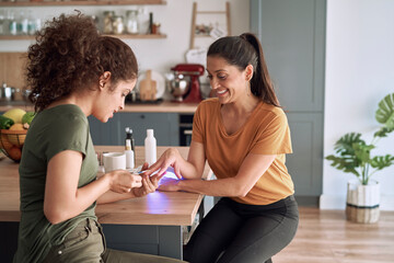 Happy women making nail beauty treatments