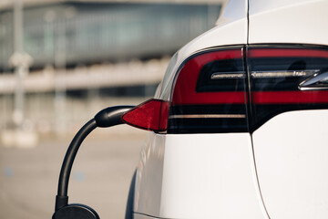 Electric vehicle charging port plugging in EV modern car. Save ecology alternative energy...