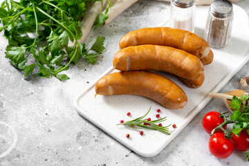 Sausages Bockwurst. Sausages Bockwurst on white serving Board on a light gray table. German sausages closeup	