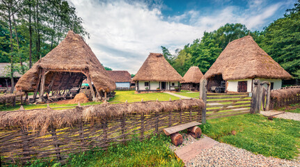 Fototapeta na wymiar Wonderful summer view of traditional romanian peasant houses. Colorful rural scene of Transylvania, Romania, Europe. Traveling concept background.
