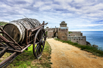 Medieval Castle Fort La Latte with old barrel on cart in Brittany, Cap Frehel, France 