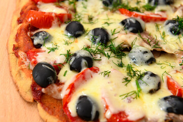 homemade pizza, vegetarian food, baked vegetables and cheese, tomatoes and olives, delicious food on a wooden background