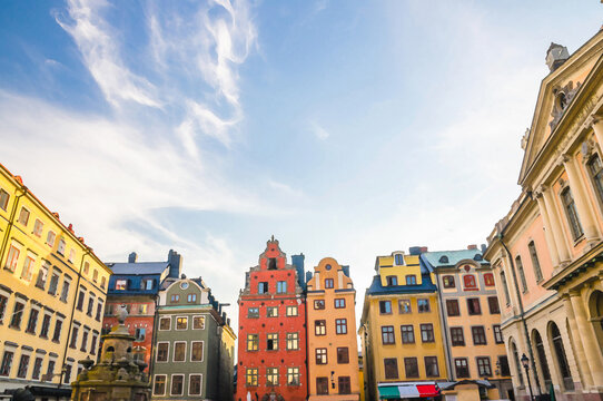 Watercolor drawing of Traditional buildings with colorful walls, Nobel Museum and fountain on Stortorget square in old historical town quarter Gamla Stan of Stadsholmen island, Stockholm, Sweden