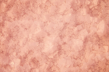 Crystals of pink salt at the bottom of the lake through pink water. Salt background in defocus