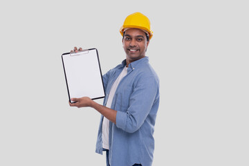Construction Worker Showing Clipboard Wearing Yellow HardHat. Isolated