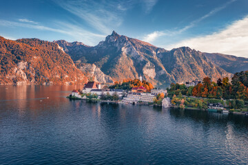 View from flying drone of Maria Kronung church. Colorful autumn scene of Traunsee lake. Beautiful landscape of Austrian Alps with Traunstein peak on background, Austria, Europe.