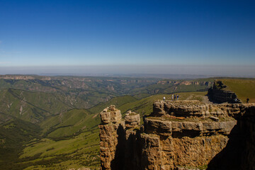 A beautiful gorge in the Caucasus Mountains. Blue sky and huge rocks. Bermamyt plateau