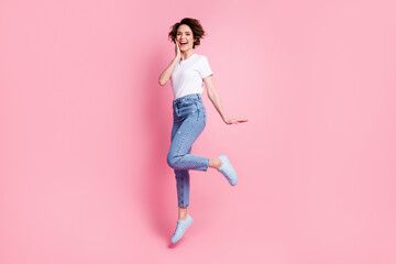 Fototapeta na wymiar Full length body size view of attractive cheerful cheery brown-haired girl jumping having fun isolated over pink color background