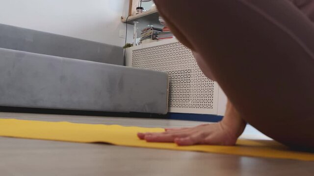 Beautiful young woman doing yoga at home. asanas on yoga mat. Vintage tonned. close up Shot video. Slow motion.
