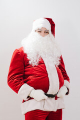 Fototapeta na wymiar Pot-bellied Santa Claus, held by his hands for a belt