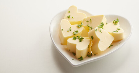 Heart-shaped butter patties with parsley