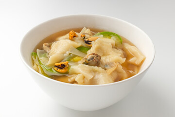 Seafood sujebi on a white background