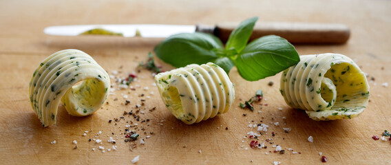 Row of three stylish butter curls with herbs