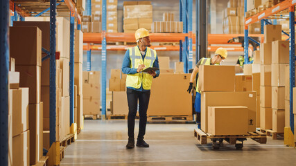 Handsome Male Worker Wearing Hard Hat Holding Digital Tablet Computer Walking Through Retail...