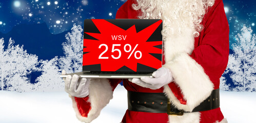 santa holds laptop with 25 percent winter sale advertising on wintery background