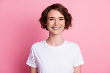 Close-up portrait of nice attractive cheerful brown-haired girl wearing casual comfy tshirt isolated over pink pastel color background
