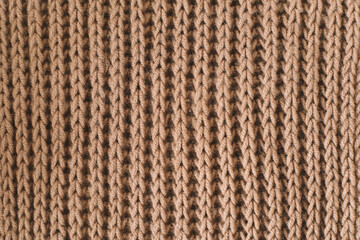 Knitting pattern of wool. Knitting. Texture of knitted woolen fabric for wallpaper and an abstract background