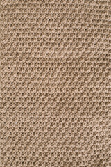 Knitting pattern of wool. Knitting. Texture of knitted woolen fabric for wallpaper and an abstract background