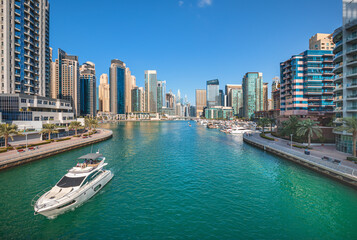 Fototapeta na wymiar Dubai Marina skyline with yachts in the canal and famous promenade, Dubai, United Arab Emirates