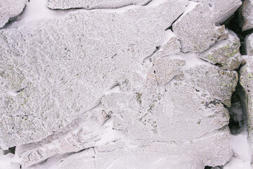 Forest stone covered with frost, winter background