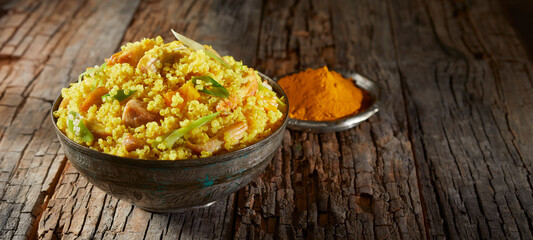 Heaped bowl of savory quinoa and couscous