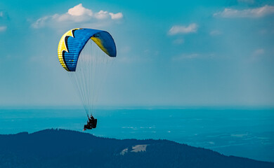 Beautiful alpine view with a paraglider high above the famous Tegernsee at the Wallberg, Rottach-Egern, Bavaria, Germany