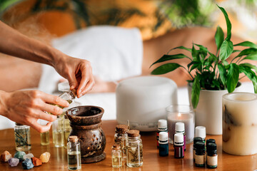 Obraz na płótnie Canvas Ayurveda Aromatherapy Massage, Pouring Aromatic Oil in Essential Oil Diffuser