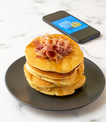 A fresh made pancake with crispy bacon and syrup, traditionale Dutch recipe