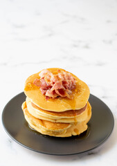 A fresh made pancake with crispy bacon and syrup, traditionale Dutch recipe