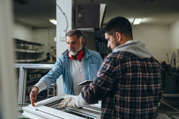 Aluminium and PVC industry workers making PVC frames for windows