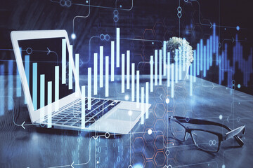 Forex market graph hologram and personal computer on background. Multi exposure. Concept of investment.