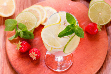 A glass of lemonade with mint, strawberries and ice. View from above.