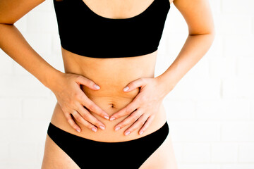 female belly on white background. Abdominal pain. Horizontal frame. Selective focus photo with noise effect