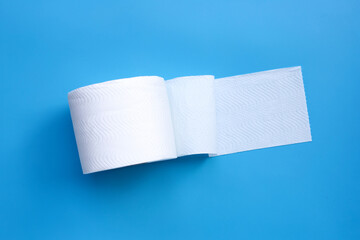 Toilet paper on blue background. Copy space