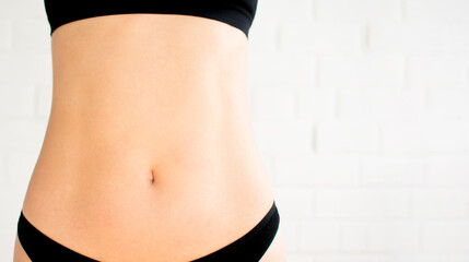female belly on a white background. Selective focus photo with noise effect - obrazy, fototapety, plakaty