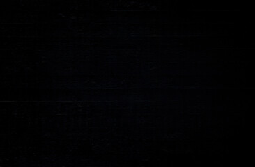 Front view of a black, plastered and uneven concrete wall. Dark gray, almost black, high resolution full frame textured background.