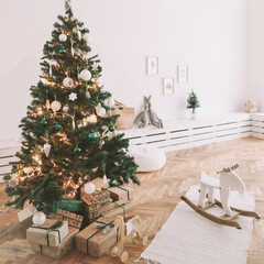 Christmas home interior. Christmas tree toys and gifts. New Year home decorations