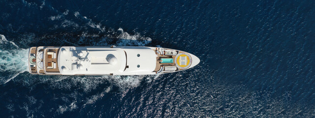 Aerial drone ultra wide photo of luxury yacht with wooden deck anchored in tropical exotic island...