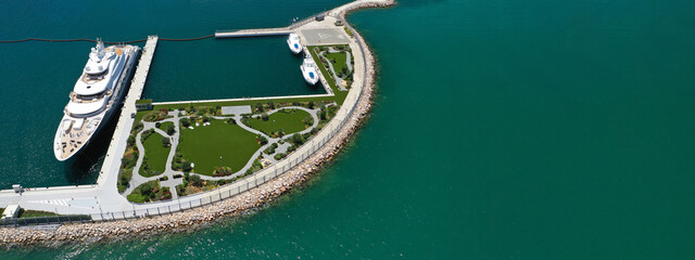 Aerial drone top down ultra wide photo of small Mediterranean port with anchored yachts