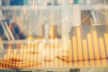 Financial chart drawing and table with computer on background. Double exposure. Concept of international markets.