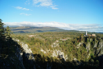 Fototapeta na wymiar Skocjan village in Škocjan Caves Regional Park, mountains in Slovenia, October 2016