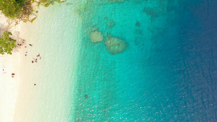 Tropical sandy beach with wave and turquoise water,copy space for text, aerial view. Sea water surface in lagoon. Transparent turquoise ocean water surface. Background texture