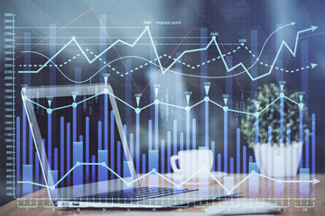 Naklejka premium Forex market graph hologram and personal computer on background. Double exposure. Concept of investment.
