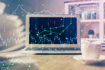 Financial graph colorful drawing and table with computer on background. Double exposure. Concept of...