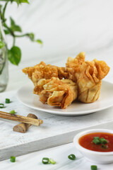 Siomay or Siomay Goreng, Indonesian popular street food, made from fish, shrimp wrapped with dumpling wrapper, steamed and deep fried, served with spicy tomato sauce or peanut sauce. Selective focus. 