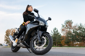 Fototapeta na wymiar Stylish biker girl on motorcycle