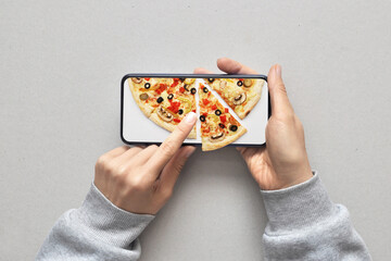 A person chooses a pizza over the Internet looking at the phone. Buy products online. Fast pizza...