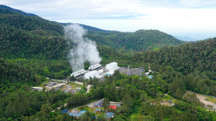 Aerial drone of Geotermal power plant on Mount Apo. Geothermal station with steam and pipes in the rainforest. Mindanao, Philippines.