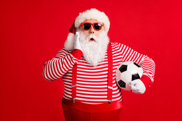 Portrait of his he nice handsome attractive amazed stunned fat overweight Santa grandfather playing football omg wow reaction isolated over bright vivid shine vibrant red color background